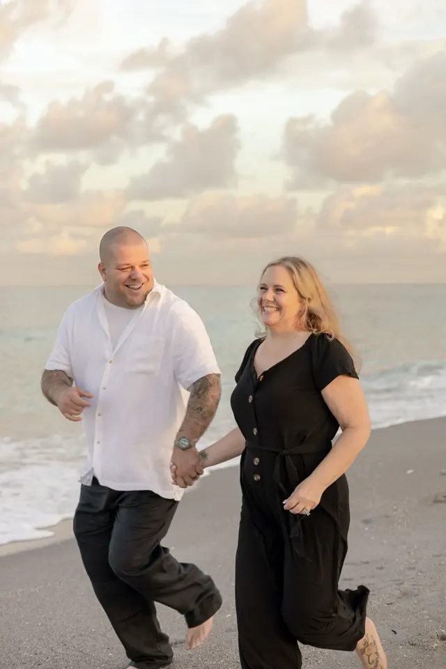 Couple walking barefoot on the beach