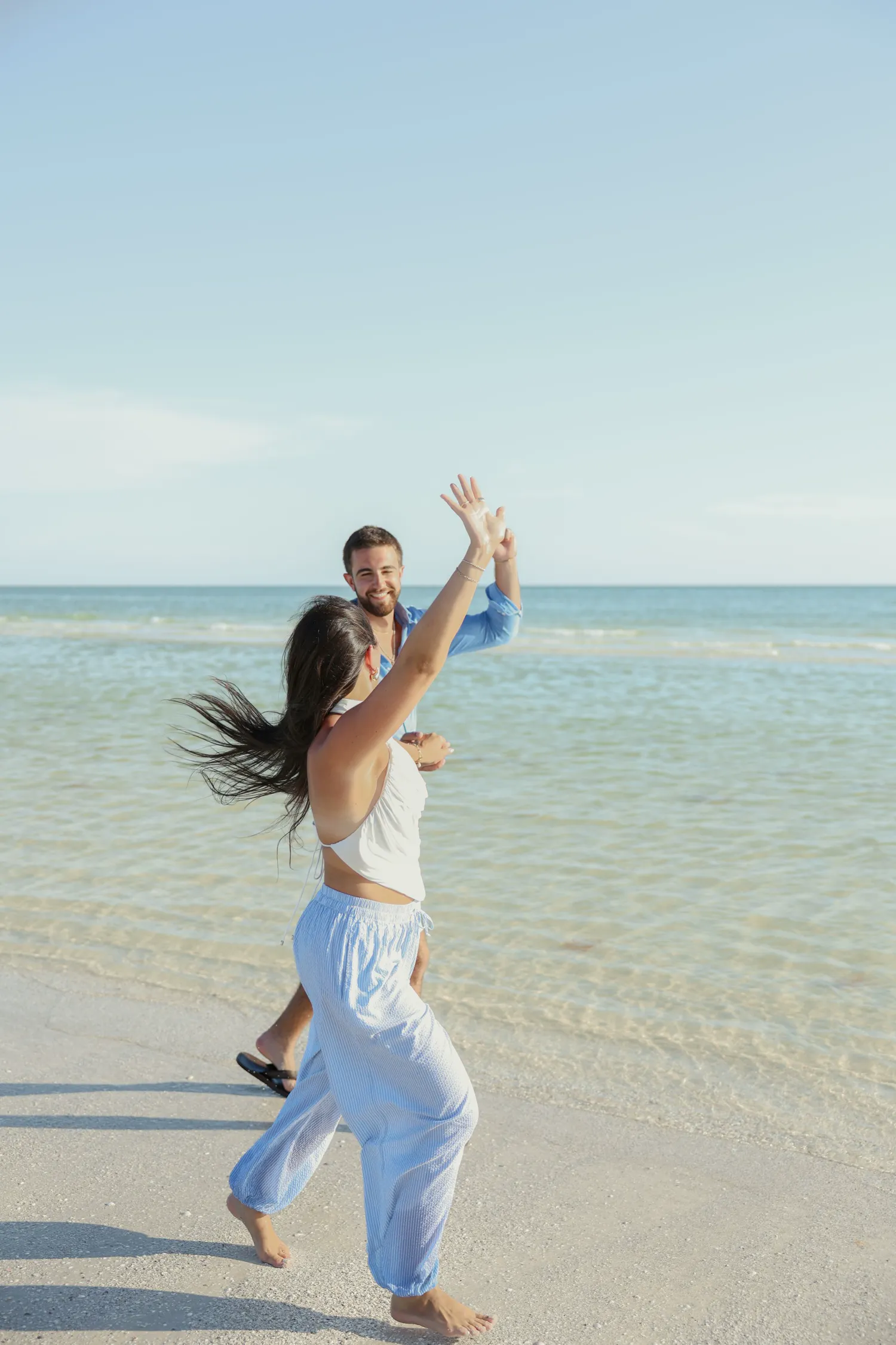 Couple dancing in the shallow turquoise water