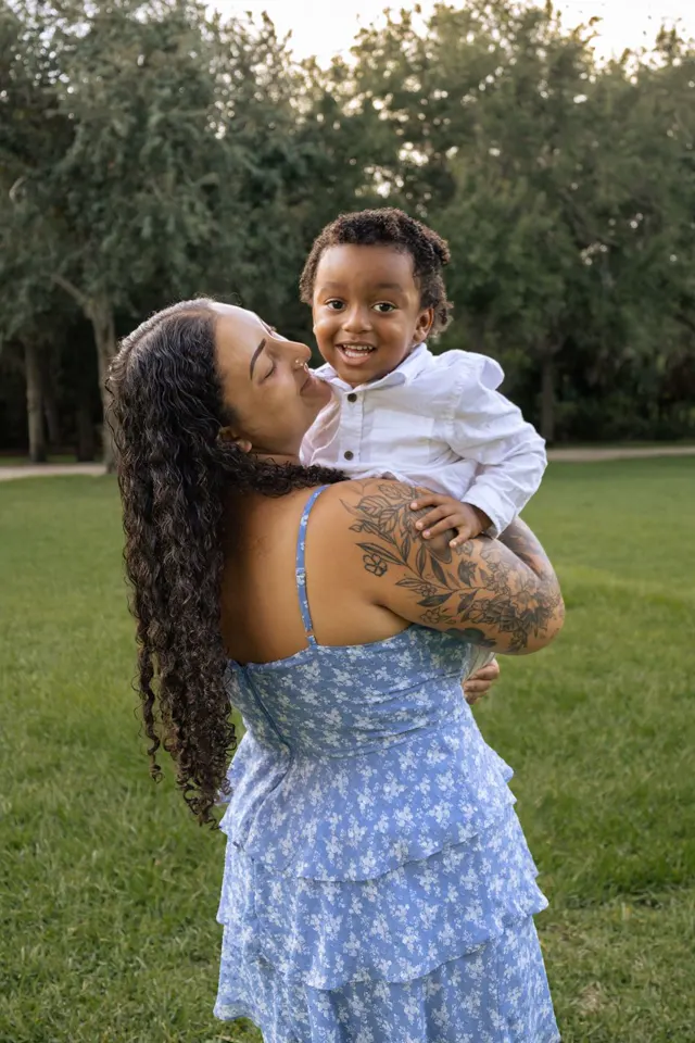 Mom holding her smiling son on her hip