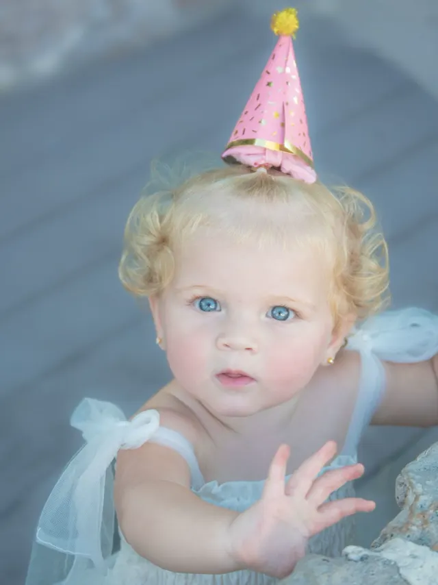 Baby in a pink party hat